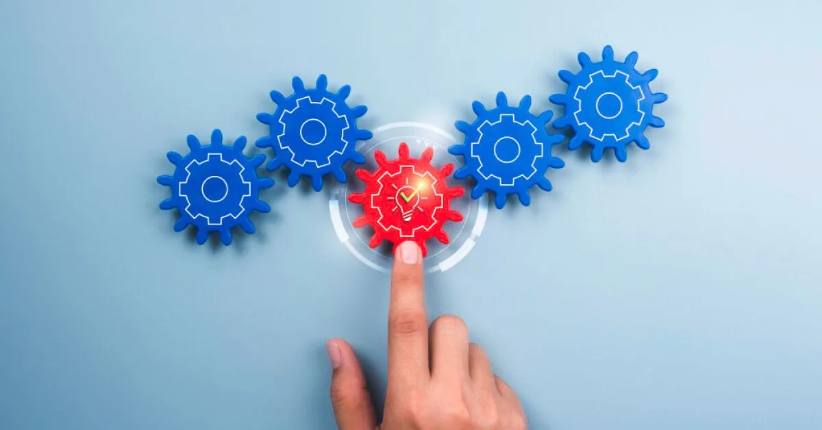 Person interacting with a set of gears and holographic visuals